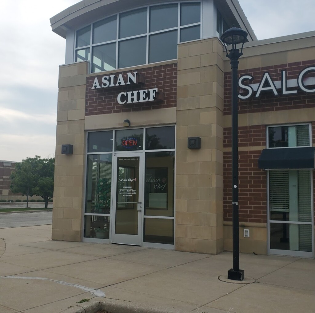 The exterior door, sign, and facade of a restaurant named Asian Chef.